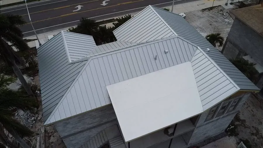 Grey standing seam metal roof beachside home Naples FL