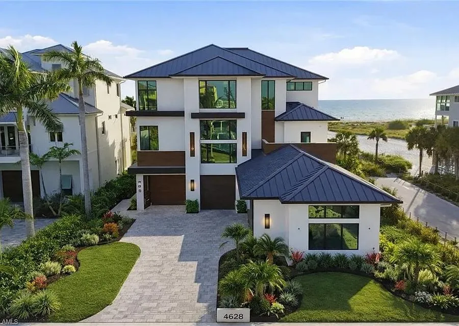 Luxury coastal home standing seam metal roof Bonita Springs FL