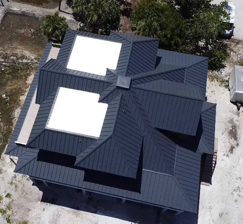 Charcoal standing seam metal roof new construction aerial drone view Southwest Florida